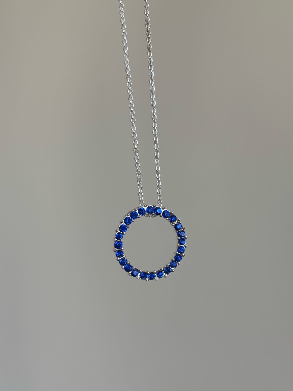 Blue sapphire open circle silver plated necklace